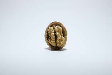 Delicious organic walnut with nutshell isolated on a white background