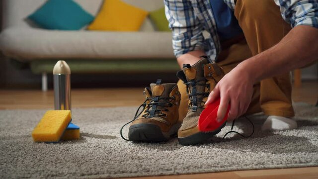 Close up man cleans shoes from dirt with a special brush