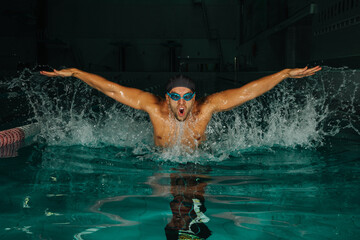 Swimmer in swimming pool with splashes