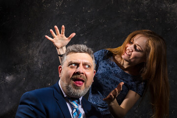Bearded man and young woman, happy couple studio portrait..