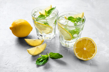 Cold refreshing lemonade or mojito on gray background. Colors 2021.