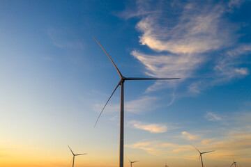 Fototapeta na wymiar Industrial landscape. Wind generators turbines. Colorful sky and sunset. Green renewable energy