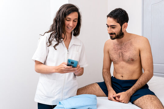 Women Physiotherapist Talking With A Patient.