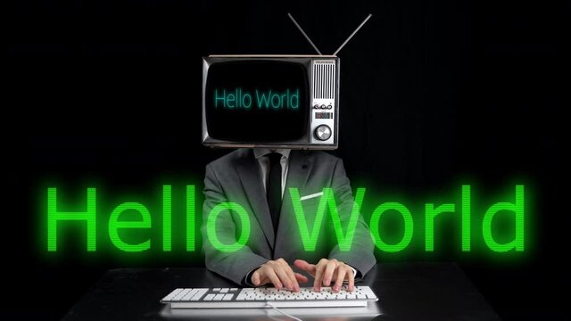 Man typing with TV on head and hello world message