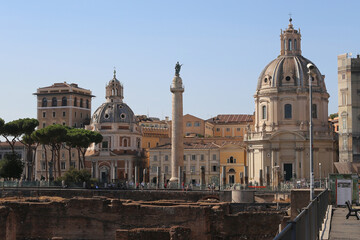Trajan's column with the statue of the Apostle Peter in the background of the Palazzo Valentini