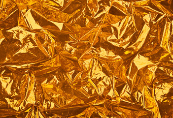 Abstract background of golden crumpled plastic