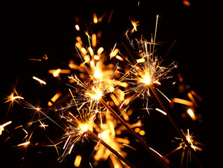 Close up several firework sparklers over black
