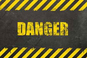 Concrete background with grunge danger sign