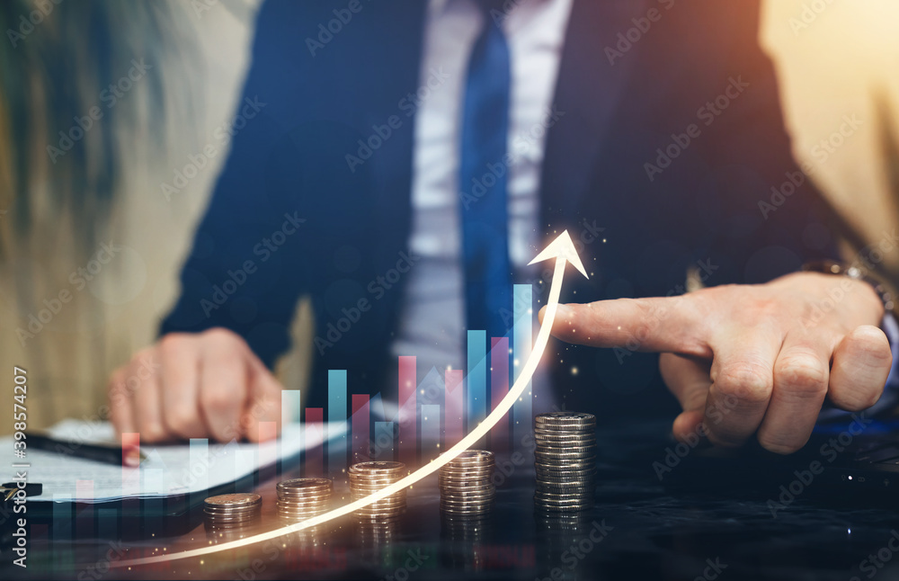 Wall mural businessman pointing graph growth above stacks of coins. business development to success and growth 