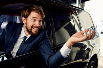 business man in suit driving car in showroom and emotions model