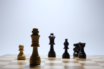 Checkmate concept. Chess board game concept background. Wood chess pieces on board game. Selective focus area. 