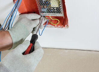 A worker is installs and connects the power supply of LED backlight.