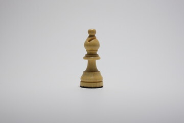 White wooden chess bishop  isolated on a white background.