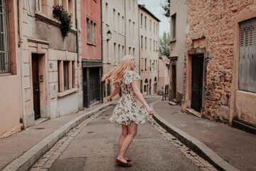 Woman in a Dress Dancing on a Street