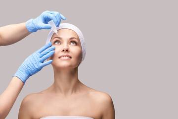 Girl with eye drops. Doctor hands applying eyewash. Recovery cataract procedure. Conjunctivitis...
