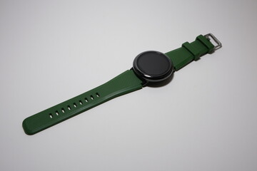 Touchscreen watch with green wristband isolated on a white background