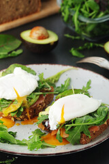 Homemade sandwiches with salmon, avocado and poached eggs