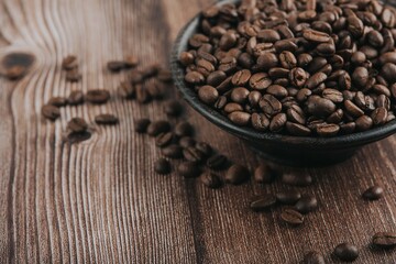 A roasted coffee beans texture  . Roasted coffee beans on wooden floor 