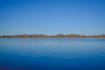 a body of water with hills in the background