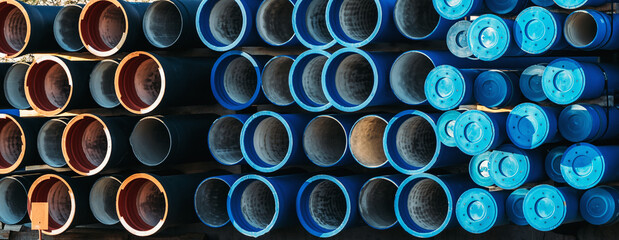Plastic pipe background, big PVC pipes in stack for water and drain or wastewater. - obrazy, fototapety, plakaty