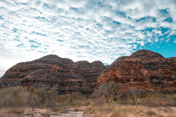 a landscape with a mountain in the background