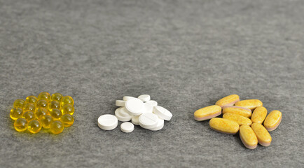 Health. Close-up of a tablet with clear capsules or soft gel capsules with omega-3 and vitamins c...