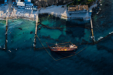 Top view of an old tanker that ran aground and overturned