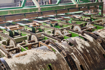 fragment of a line of sawmill equipment inside a modern lumber mill