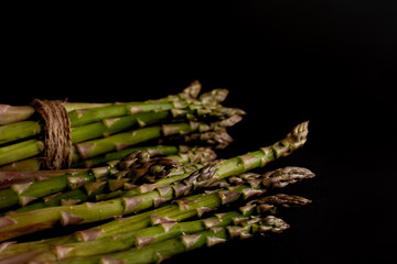green asparagus on black background