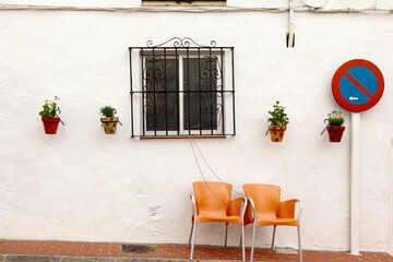 Fototapeta na wymiar Two Orange Chairs in Front of a House