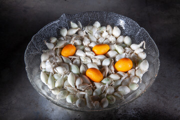 Four Kumquats and Small Onions in Glass Plate