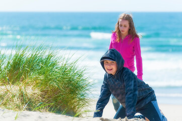 Boy and Gril Playing on Coastal beach