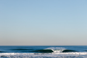 Fototapeta na wymiar Big Waves break in the Pacific Ocean on a California beach