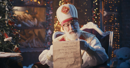 Fototapeta na wymiar Saint Nicholas reading letters and checking list