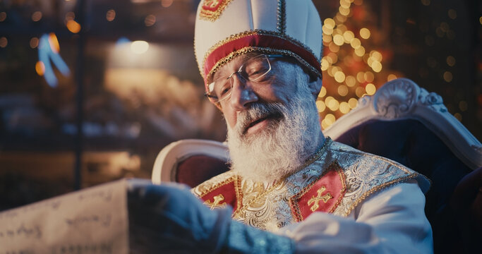 Bearded Saint Nicholas comparing letters with list