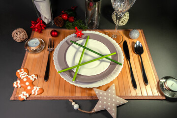 Christmas table setting. New year's eve. The time of the gala dinner. Cutlery on a wooden napkin and holiday decorations. The view from the top.