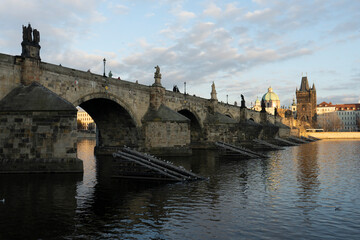 .stones charles bridge over vltava river and blue sky at sunset in the center of prague