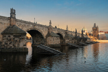 Fototapeta na wymiar .stones charles bridge over vltava river and blue sky at sunset in the center of prague