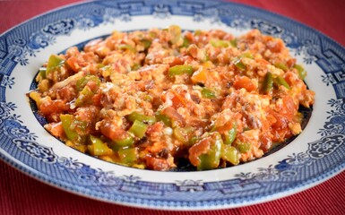 Traditional breakfast dish made of mixing tomatoes pepper and eggs