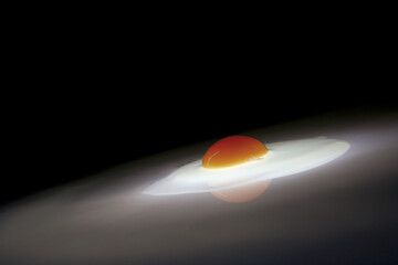 Cracked egg on dark background