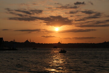 Fototapeta premium Lovely sunset and small boats with city background