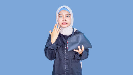 asian hijab woman holding wallet, shocked and afraid for mistake. surprised expression