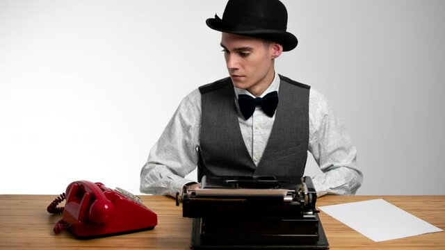 Businessman wearing bowler using typewriter