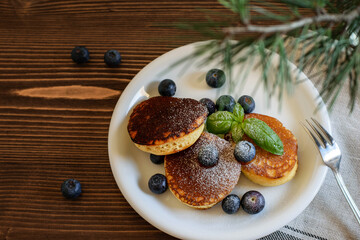Traditional japanese pancakes on the white plate. Wooden background, top view.