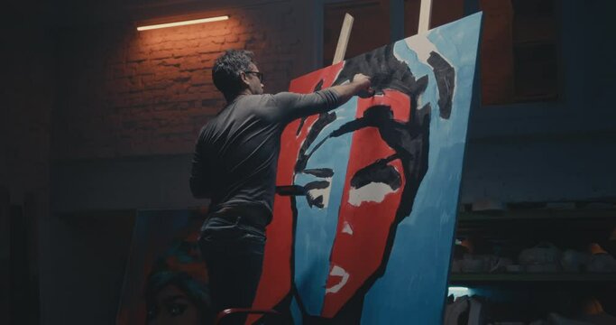 Man painting creative portrait in studio