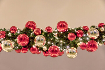 Outdoors Christmas decorations garland with fir branches, red and yellow baubles and lights