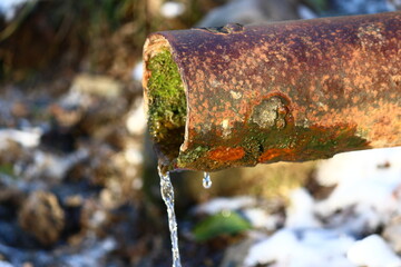 Metal pipe with flowing spring water
