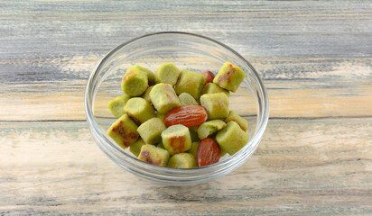 Japanese edamame and almond snack food in glass snack bowl on table