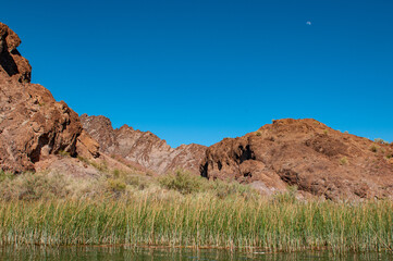 Fototapeta na wymiar moon over red mountains in the desert