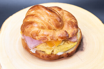 Delicately prepared Mexican breakfast croissant sandwich with eggs and ham to start off your day eating right.